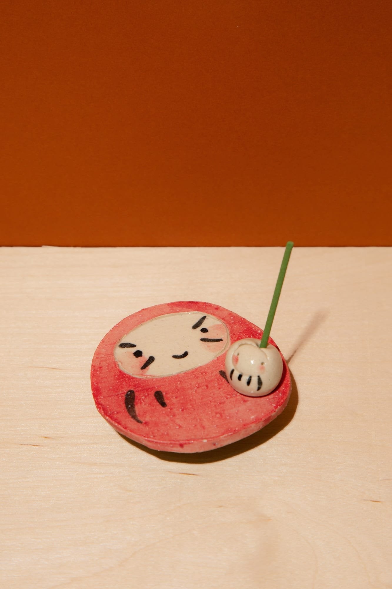 Red and white Bodhidharma ceramic incense holder